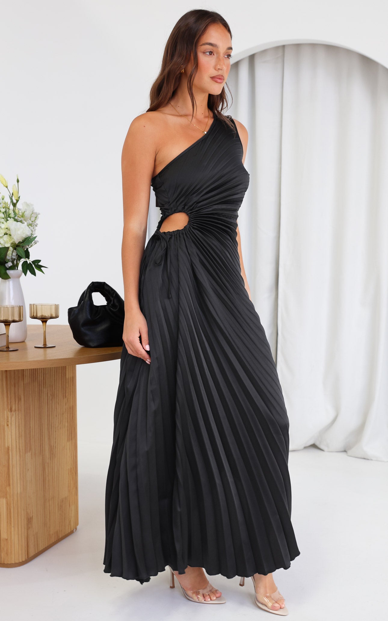 ROCHELLE ONE SHOULDER SLEEVELESS ADJUSTABLE SIDE CUT OUT ASYMMETRIC PLEATED MAXI DRESS - BLACK By Amica ROCHELLE ONE SHOULDER SLEEVELESS ADJUSTABLE SIDE CUT OUT ASYMMETRIC PLEATED MAXI DRESS - BLACK By Amica