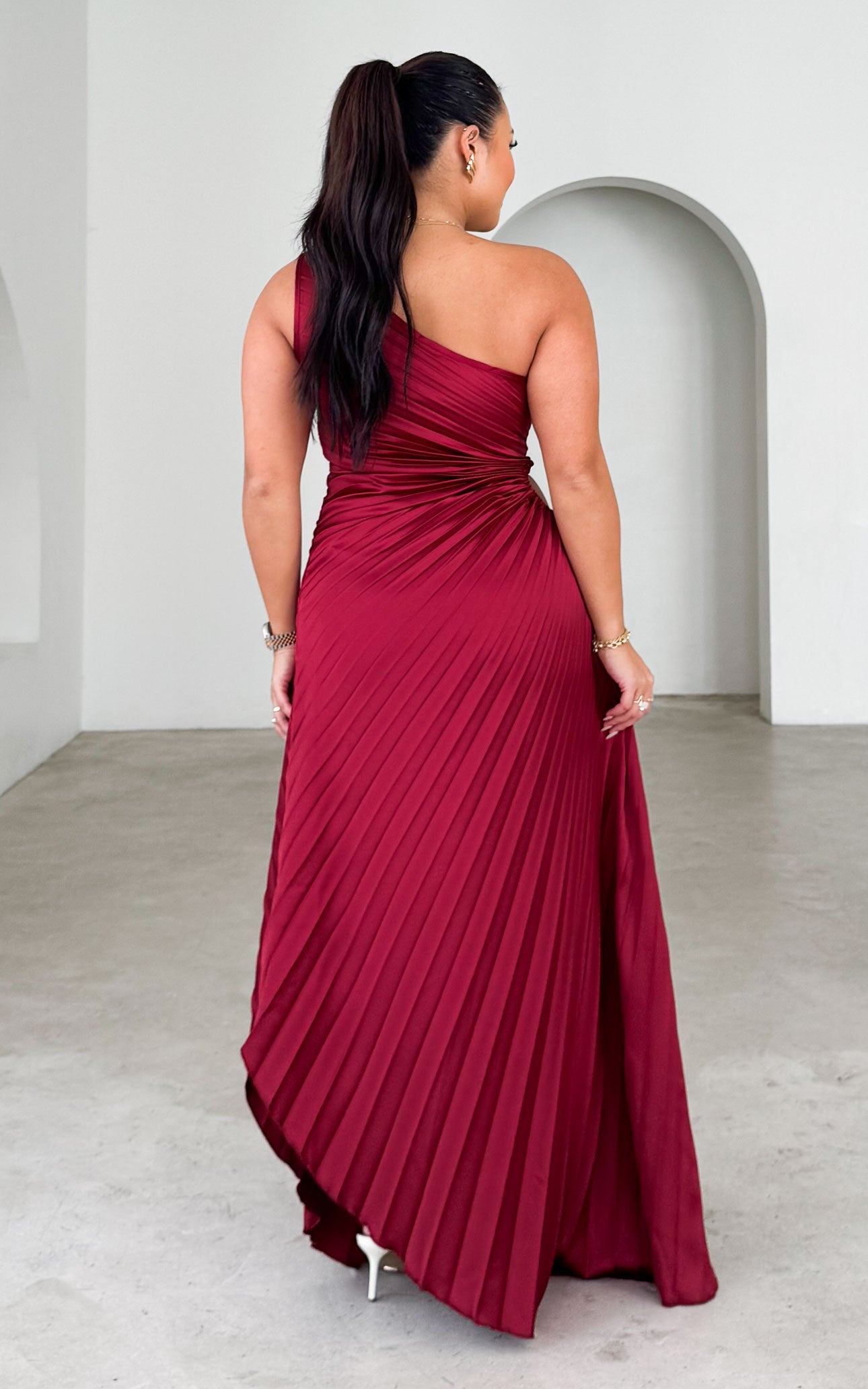 ROCHELLE ONE SHOULDER SLEEVELESS ADJUSTABLE SIDE CUT OUT ASYMMETRIC PLEATED MAXI DRESS - WINE By Amica ROCHELLE ONE SHOULDER SLEEVELESS ADJUSTABLE SIDE CUT OUT ASYMMETRIC PLEATED MAXI DRESS - WINE By Amica
